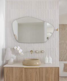 a bathroom with a sink and mirror on the wall