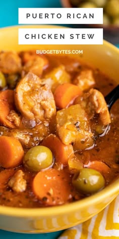 a yellow bowl filled with chicken stew and olives