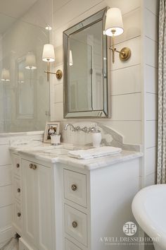 a bathroom with a sink, mirror and bathtub