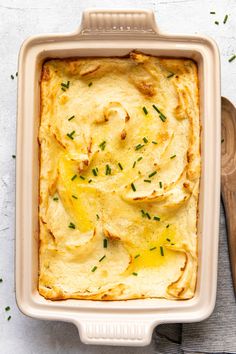 a casserole dish filled with potatoes and cheese