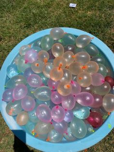 a blue bowl filled with lots of balloons