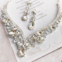 a necklace and earring set on top of a card