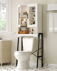 a white toilet sitting next to a bathroom sink