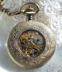 "Dragon pocket watch, men's mechanical pocket watch with a dragon theme. Pocket watch features a 13\" bronze dragon watch fob, dragon is 6 1/2\". The watch has a black dial featuring silver numerals. This is a mechanical self wind watch that needs no batteries. The watch case is a rich bronze and front cover opens to reveal watch face, you can see the gold cogs and inner watch workings on the back of the watch.. This bold and unique pocket watch would be a great addition to your own collection o Steampunk Silver Pocket Watch With Metal Dial, Silver Steampunk Pocket Watch With Metal Dial, Gold Engraved Steampunk Pocket Watch, Steampunk Pocket Watch With Metal Dial For Formal Occasions, Steampunk Metal Dial Pocket Watch For Formal Occasion, Gold Steampunk Pocket Watch With Locket, Steampunk Bronze Pocket Watch With Locket, Bronze Steampunk Pocket Watch With Locket, Dragon Watch