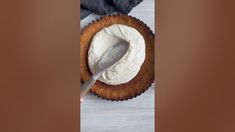 a cake with white frosting and a spoon in it