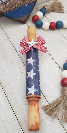 a wooden toy with an american flag on it next to other toys and beads in the background