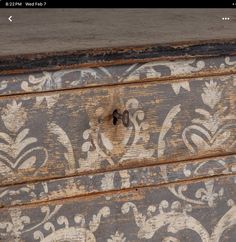 an old wooden chest with ornate designs painted on it