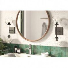 a bathroom sink with a mirror above it and soap dispensers on the wall