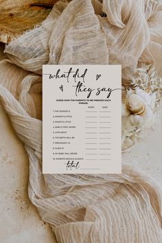 a wedding game with the words what did they say? written on it next to some seashells