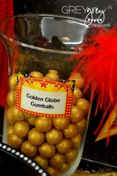 a glass vase filled with golden globe gumballs