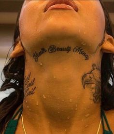 a woman with tattoos on her neck and chest