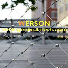 a chain link fence with the words person on it and an image of a building in the background