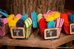 colorful flip flops are on display in baskets