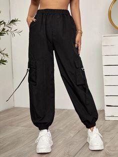 Add an edgy touch to your outfit with these black Tape Panel Flap Pocket Cargo Pants. These pants feature tape panel details that create a unique and eye-catching design element. The flap pockets on the sides add a functional and stylish touch, providing extra storage space. Made from high-quality materials, these cargo pants offer durability and comfort. Specifications: Style: Casual Type: Cargo Pants Details: Pocket, Tape Waist Line: High Waist Length: Cropped Fit Type: Regular Fit Fabric: Non Sporty Black Cargo Pants For Work, Edgy Cargo Pants With Pockets For Work, Black Sporty Parachute Pants, Trendy Black Parachute Pants With Cargo Pockets, Edgy Black Cargo Pants For Work, Sporty Black Cargo Style Pants, Black Sporty Parachute Pants With Multiple Pockets, Trendy Black Parachute Pants With Side Pockets, Trendy Black Cargo Pants With Pockets