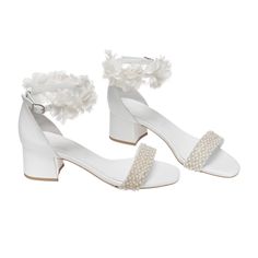 Discover the charm of short block heels for weddings! Find low block heel wedding shoes for brides, ensuring style and comfort on your big day. Step into elegance and comfort with our handcrafted Short Block Heels in White, adorned with delicate white fabric flowers and lustrous pearls. Each step is cushioned by the double-padded insole, ensuring a soft and luxurious feel with every stride. The genuine leather uppers and insole offer durability and breathability, while the soft leather tie-up st Short Block Heels, Block Heel Wedding Shoes, Shoes For Brides, Heels White, Leather Industry, Leather Tie, Bridal Heels, Wedding Shoes Heels, Womens Wedding Shoes