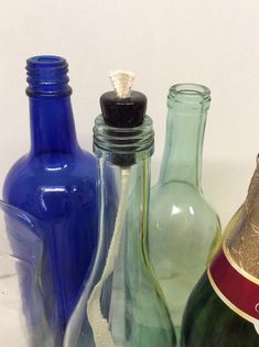 several different colored glass bottles lined up together