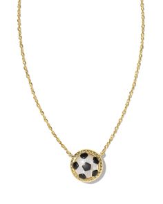 a gold necklace with a black and white soccer ball hanging from it's center