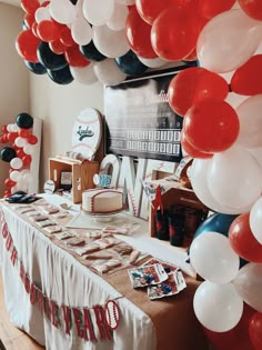 a baseball themed party with balloons and cake