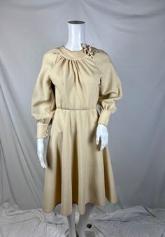 "Vintage Handmade Cream Dress  MIDI Length Dress Cute Tie Detail on Neck Fit and Flare  Heavy Cotton Material Measurements  Bust - Oversized 36\" Waist - 28\" Hips - Free Length - 40\"" Retro A-line Vintage Dress For Fall, Vintage A-line Midi Dress For Fall, Vintage Long Sleeve Beige Midi Dress, Vintage Beige Long Sleeve Midi Dress, Beige Long Sleeve Vintage Midi Dress, Vintage Cream Dress For Fall, Retro Beige A-line Dress, Vintage Midi Length Dresses For Vintage Fashion, Vintage Midi-length Dresses