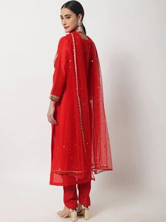 This is a beautiful 3 piece suit set. It comes with solid straight cut kurta has gota detailing, embellish work, 3/4th sleeves, round neck, calf length teamed with solid trouser pants and a net dupatta. 3 piece set Color- Red Work- Gota Embellish Kurti Length-46 inch Kurta Fabric-Silk Bottom Fabric-Silk Dupatta Fabric-Net Sleeves-3/4th Sleeves Neck-Round Neck Care - Dry Clean Unstitched Mirror Work Suit For Celebration, Unstitched Suit With Mirror Work For Celebration, Celebration Unstitched Suit With Mirror Work, Celebration Sets With Sheer Dupatta And Straight Kurta, Formal Anarkali Kurta With Gota Work, Elegant Churidar With Mirror Work For Celebration, Embellished Suit, Net Sleeves, Elegant Suit