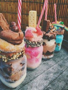 four different flavored ice cream sundaes on a table