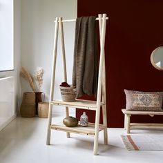 a wooden shelf with two baskets on top of it next to a mirror and other items