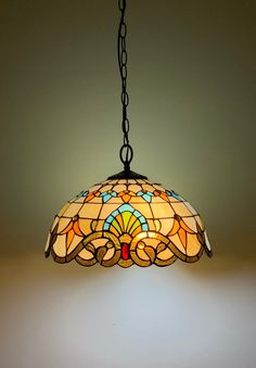 a stained glass light hanging from a chain