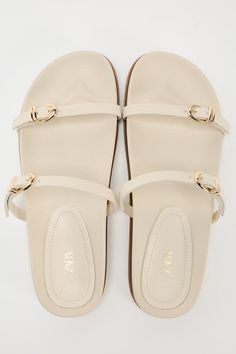 BUCKLED STRAP SANDALS - Off White | ZARA United States Flat Sandals With Tang Buckle, Beach Slides With Tang Buckle, Beige Double Strap Sandals With Buckle Closure, Summer Footbed Sandals With Tang Buckle And Flat Heel, Summer Toe Loop Sandals With Tang Buckle, Summer Sandals With Buckle Closure Flat Heel, Summer Sandals With Buckle Closure And Flat Heel, Flat Sandals With Tang Buckle For Beach, Flat Tang Buckle Sandals For The Beach