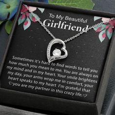 a necklace with a heart in the middle and an inscription on it that says to my beautiful girlfriend