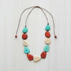 Jewelry necklace adjustable, made of natural Vegetable ivory (tagua).Vegetable ivory is a product made from the very hard white endosperm of the seeds of certain palm treesProduct code: 002-02-1026-02Tagua necklace organic tagua jewelry multi colors - blue: Vegetable ivory (tagua)Made in PeruPrice including shipping by Serpost del Peru, delivery by the local post in your country.  World wide deliver Artisan Necklace With Natural Variations And Adjustable Fit, Adjustable White Earthy Necklaces, Adjustable White Earthy Necklace, White Adjustable Earthy Necklaces, White Adjustable Earthy Necklace, Artisan Hand-strung Turquoise Necklace With Round Beads, Hand-strung Turquoise Necklaces With Round Beads, Turquoise Shell-shaped Necklace For Gift, Handmade Turquoise Shell-shaped Necklace