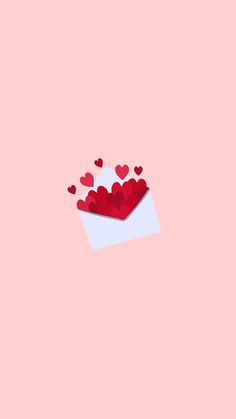 an envelope with hearts in it on a pink background