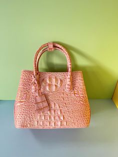 This elegant pink crocodile handbag is the perfect blend of luxury and fashion. Its structured design and bright pink color make it an ideal accessory for everyday wear and special occasions. Made from high-quality materials, this Tote bag has plenty of space inside to accommodate your daily essentials while adding a touch of sophistication to your outfit. The crocodile texture adds luxury to this bag, perfect for those who love bold fashion accessories. Whether it's for work, daily trips or evening events, this bag is your must-have fashion item. Approximate dimensions: Length 25 cm (9.8 in) width 10 cm (3.9 in) height 20 cm (7.8 in) ** Main Features  - Luxurious crocodile texture, bright pink - Spacious interior, suitable for storing daily necessities - Structured design for added elegan High-end Luxury Bags For Everyday Use, High-end Luxury Bags For Everyday, High-end Luxury Everyday Bags, High-end Luxury Top Handle Bags, Luxury High-end Top Handle Bags, Luxury High-end Bag With Top Handle, Crocodile Texture, Crocodile Handbags, Crocodile Print