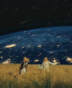 two people standing in a field looking at the earth from space with stars above them