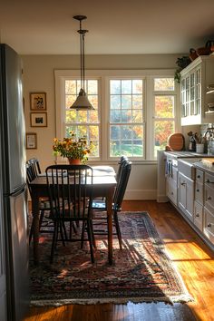 a dining room table and chairs in front of a window with the sun shining through