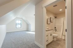 an open door leading to a bathroom with white walls