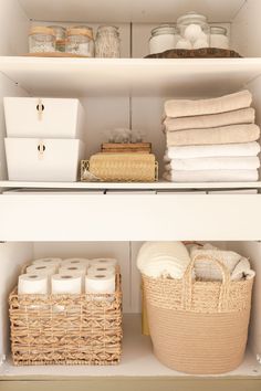 the shelves are organized with baskets, towels and other items in white linens for storage