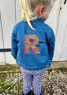 The Kids Personalised Neon Leopard Print Denim Jacket, perfect for adding a touch of style to any outfit. 100% OCS certified organic cotton Bold initial on back of jacket Bright neon colours to choose from Nickel-free front popper closure Two chest pockets Popper closure on cuffs The jacket has a classic denim design, with a poppers on the front. This is a lightweight jacket that is perfect for the Spring/Summer season. CARE INSTRUCTIONS We recommend washing inside out at 30 degrees to be kinder to the jacket and the environment. If you must tumble dry, please do so on the lowest heat setting and keep the garment inside out, same goes for ironing. Slight shrinkage of garments may occur after washing. Please note I only hold a small amount of stock. If I have your desired colour/size in sto Relaxed Fit Cotton Outerwear With Letter Print, Cotton Outerwear With Letter Print And Relaxed Fit, Fitted Cotton Outerwear With Letter Print, Fitted Fall Denim Jacket With Letter Print, Neon Leopard Print, Free Front, Neon Colours, Kids Jackets, Printed Denim Jacket