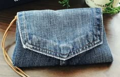 a denim purse sitting on top of a wooden table