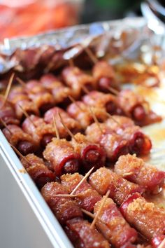 bacon wrapped in toothpicks on a tray ready to be served at a party