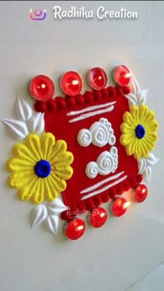 a red and yellow decorative item with candles on it