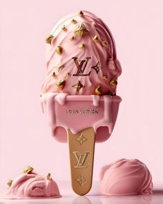 a pink ice cream sundae with gold studs on it's head and two scoops next to it