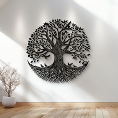 a metal tree with birds on it is mounted to the wall above a wooden floor