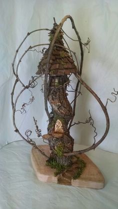 a tree house made out of branches and moss