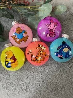 the winnie the pooh ornaments have been painted on them