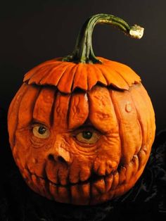 a carved pumpkin with an evil face on it