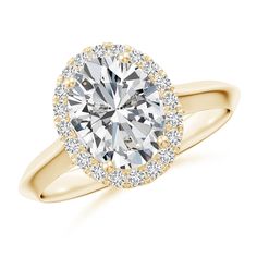 a yellow gold engagement ring with an oval cut diamond surrounded by small round brilliant diamonds