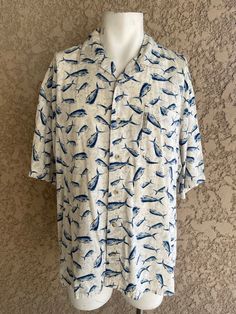 "Vintage button-up shirt with all-over fish print Made by Columbia Sportswear Size XL 55% Viscose 45% Cotton Nice soft, comfortable material. In brand new condition. Measurements laying flat Armpit to armpit 26\" (52\" total) Total length of shirt 30\" Items are shipped out within 1-2 business days. If you have any questions please feel free to message me I reply quickly. Check out the rest of my shop www.etsy.com/shop/alwaysvintagenvogue Thank you for looking and happy shopping!" White Fish Print Shirt For Summer, White Casual Shirt With Fish Print, White Short Sleeve Shirt With Fish Print, Casual Blue Tops With Fish Print, Short Sleeve Cotton Shirt With Fish Print, Cotton Short Sleeve Shirt With Fish Print, Casual White Fish Print Top, Fish Items, Fish Shirt