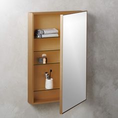 a bathroom with a mirror and shelves on the wall