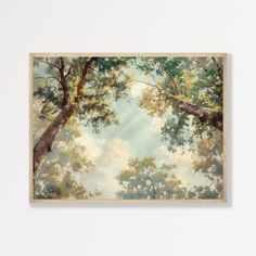 a painting hanging on the wall next to a white wall with trees and clouds in it