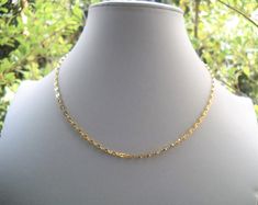 Early 70's gold plated choker - Coffee bean chain gold plated: length: see variations; made in W. Germany - Ring clasp  gold plated and rings: length - 1 cm/0.39in made in W. Germany - Length total:  40cm/ 15.7in      Total weight: 6 gr. Link: 0.4X0.3 cm/0.157X0.118in Mint vintage condition We highly recommend avoiding direct contact with water (like swimming or showering), perfumes,, and lotions. We also recommend that you take off your jewelry when you work out or go to the beach.  . Shop Poli Gold-plated Delicate Chain Choker, Gold Plated Delicate Chain Choker, Gold Link Choker For Gifts, Adjustable Gold Figaro Chain Necklace, Gold Chain Link Choker For Gift, Gold Link Chain Choker, Gold Metal Dainty Choker, Yellow Gold Choker With Gold Chain As Gift, Yellow Gold Chain Choker As Gift